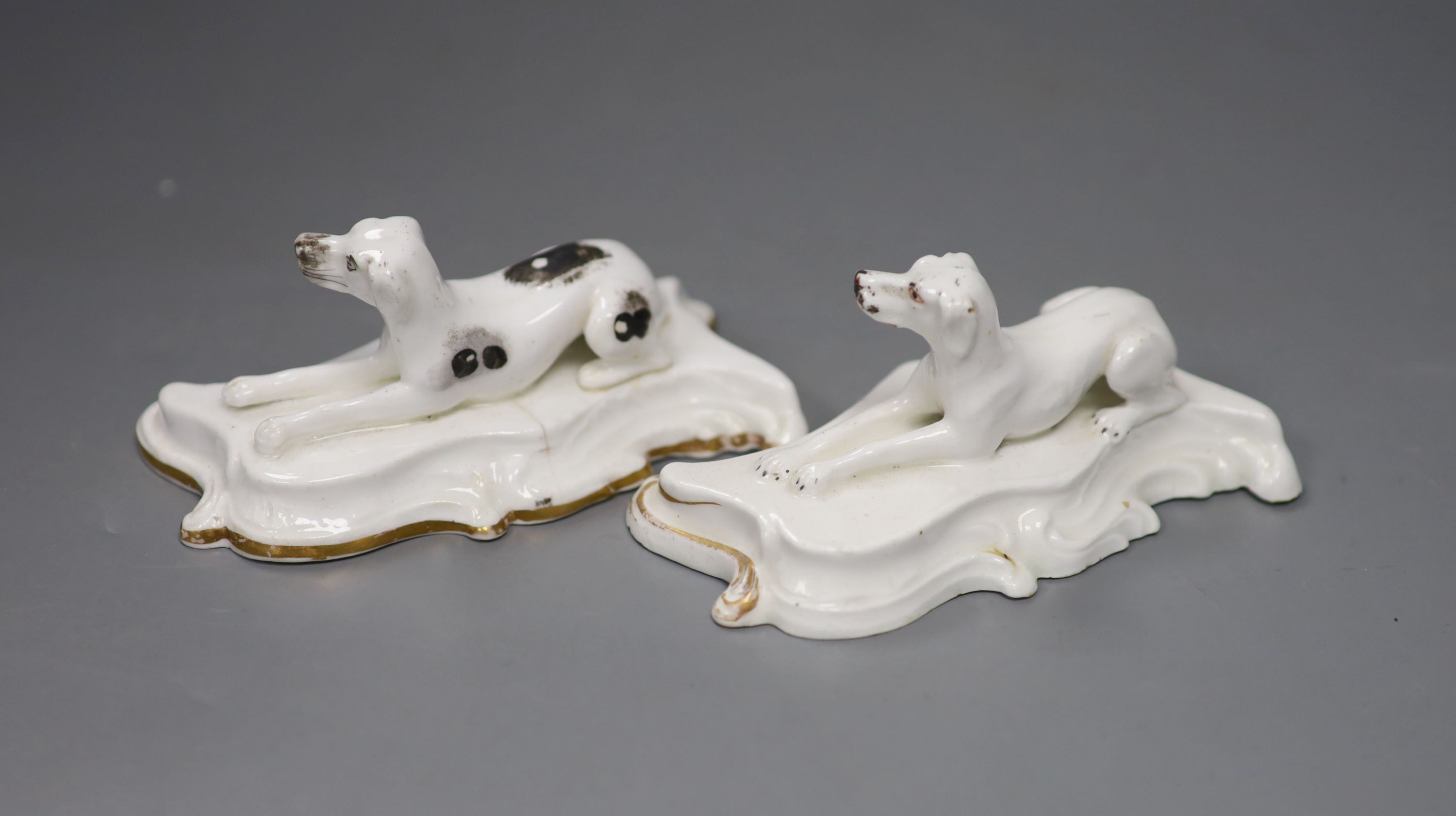 Two similar Staffordshire porcelain models of recumbent setters, c.1830-50, 12cm long